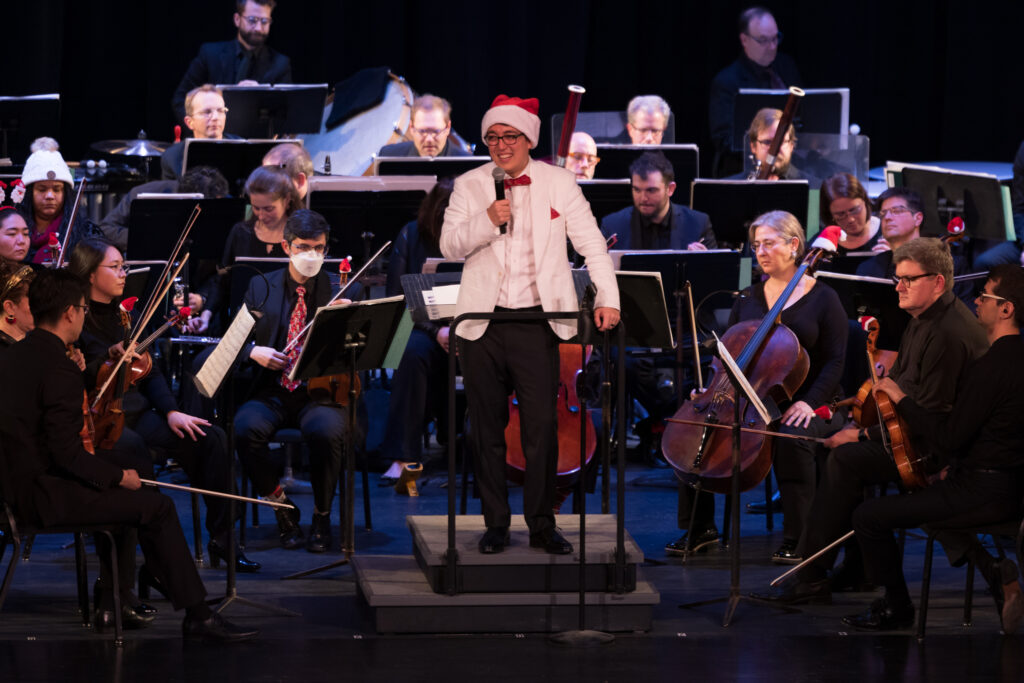 Conductor Ryan Tani speaks to the audience at the Holiday Pops Concert for West Bend Columns performed by the Milwaukee Symphony Orchestra